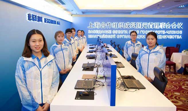 Volunteers work at registration center for 18th SCO summit in Qingdao